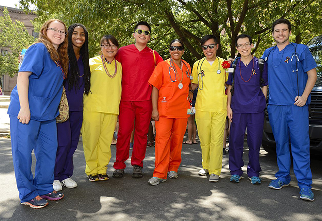 A group of nurses in rainbow scrubs